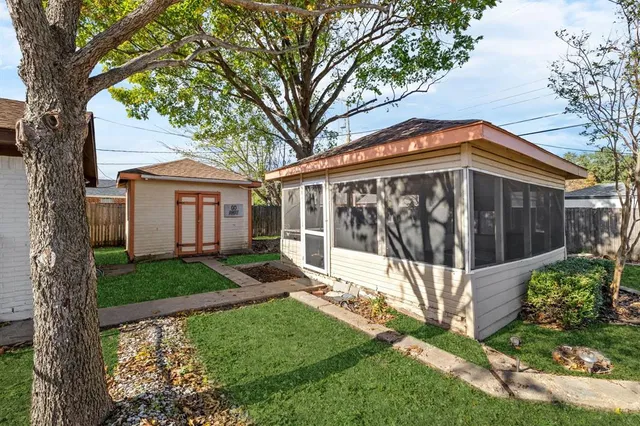 a view of a house with a yard and wooden fence