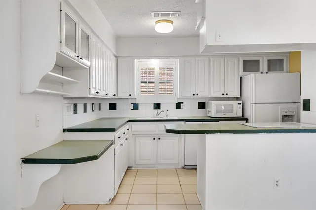 a kitchen with stainless steel appliances a sink and a stove
