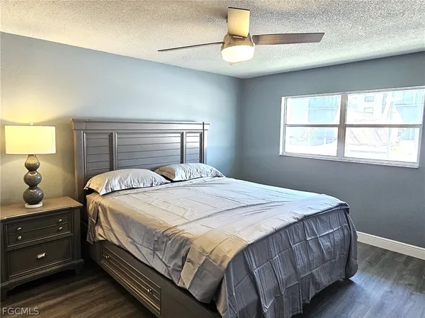 a bedroom with a bed and window with lamp