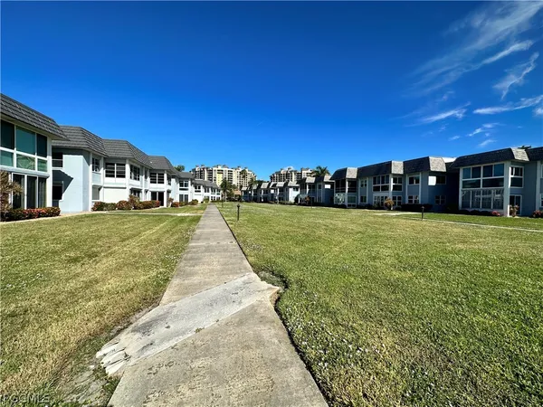 a view of a patio with a yard