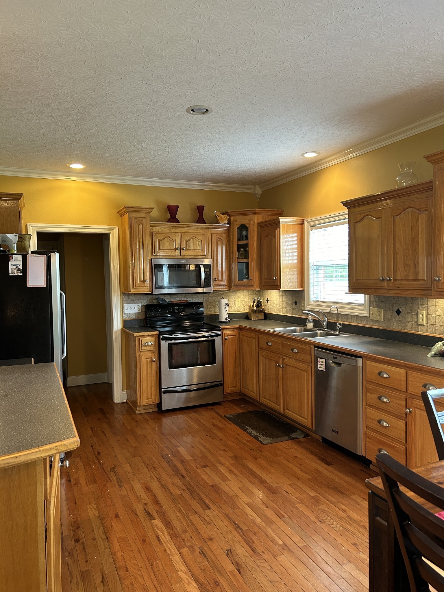 3421 George Olive Road Iron City, TN 38463 - Photo 24 of 51 a kitchen with stainless steel appliances kitchen island granite countertop a stove a sink and a refrigerator