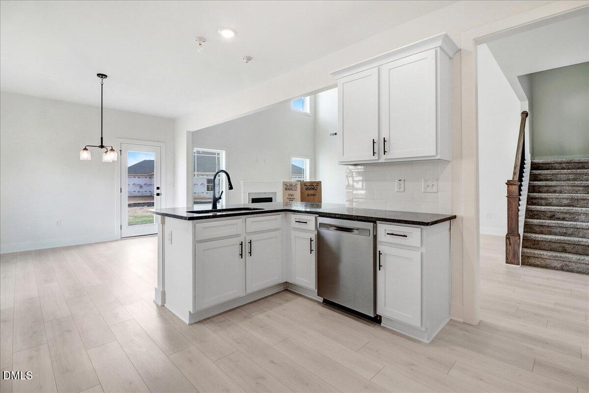 2 Galway Road Lillington, NC 27546 - Photo 12 of 37 a kitchen with kitchen island granite countertop a sink cabinets and stainless steel appliances