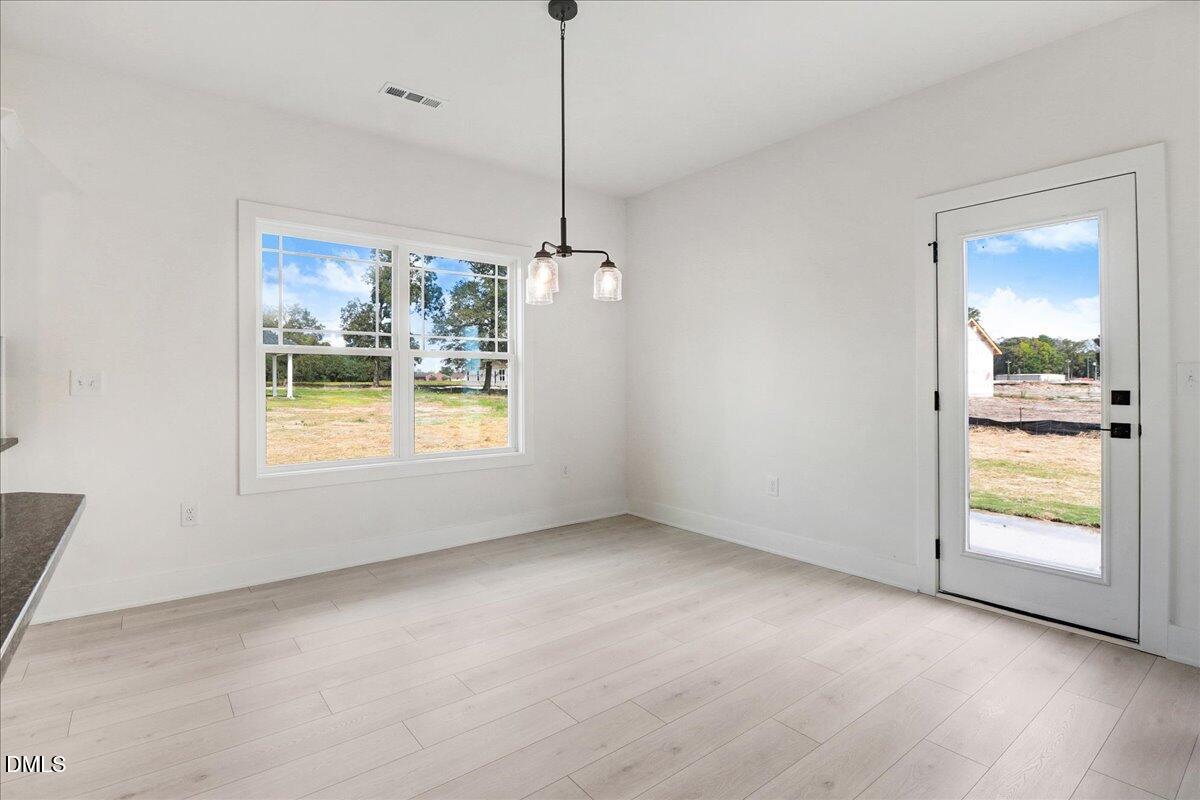2 Galway Road Lillington, NC 27546 - Photo 13 of 37 a view of an empty room with a window and kitchen view