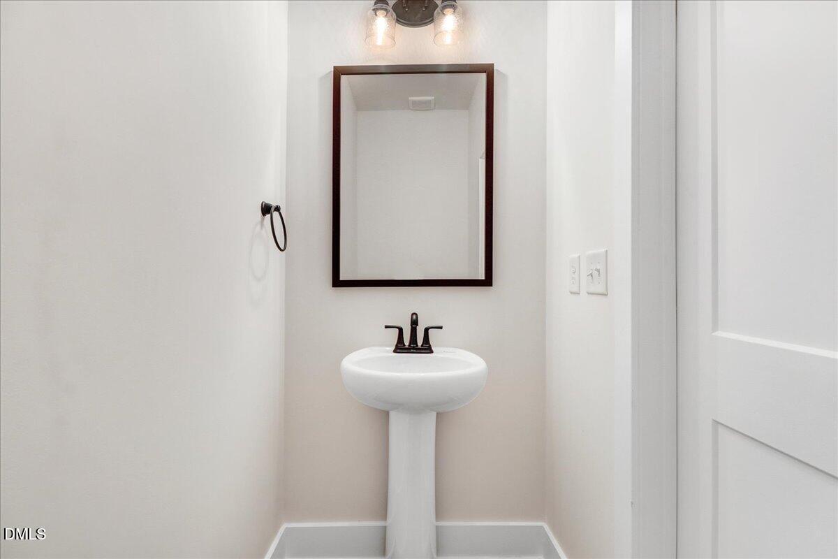 2 Galway Road Lillington, NC 27546 - Photo 15 of 37 a bathroom with a sink and a mirror