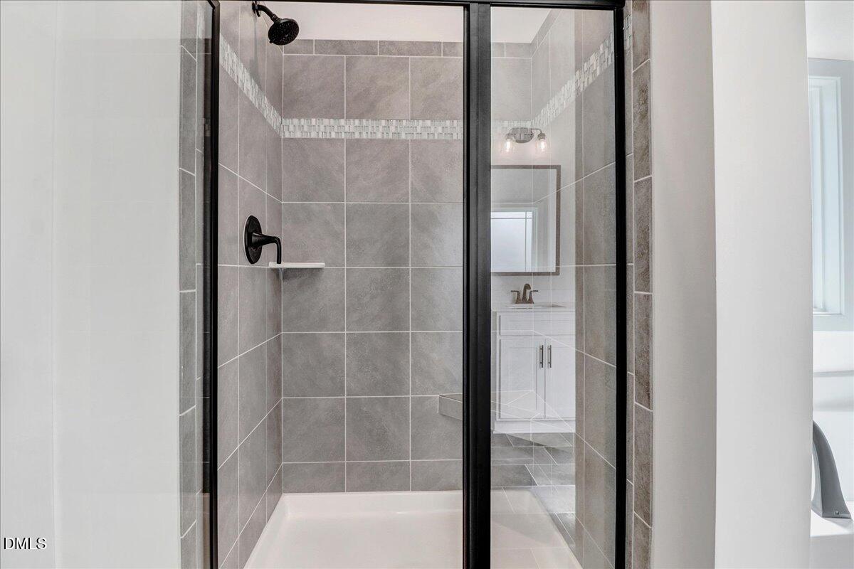 2 Galway Road Lillington, NC 27546 - Photo 22 of 37 a bathroom with a glass shower door