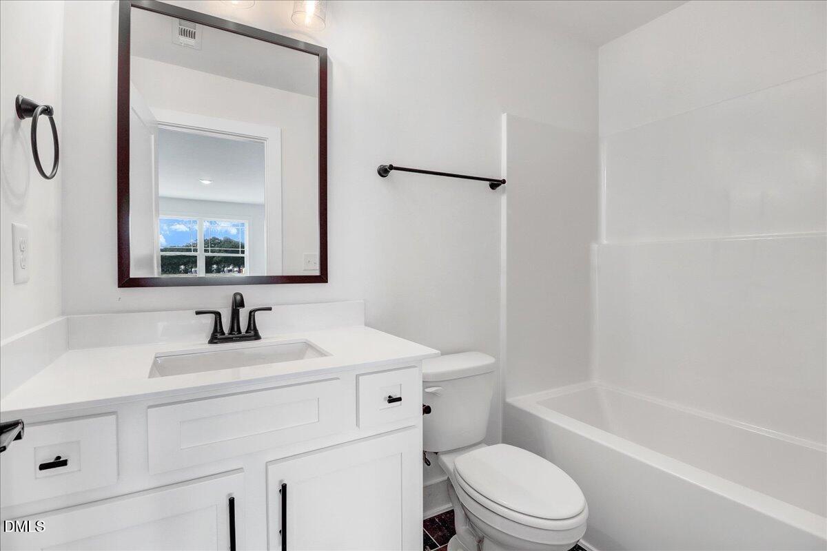 2 Galway Road Lillington, NC 27546 - Photo 26 of 37 a bathroom with a sink toilet vanity tub and shower