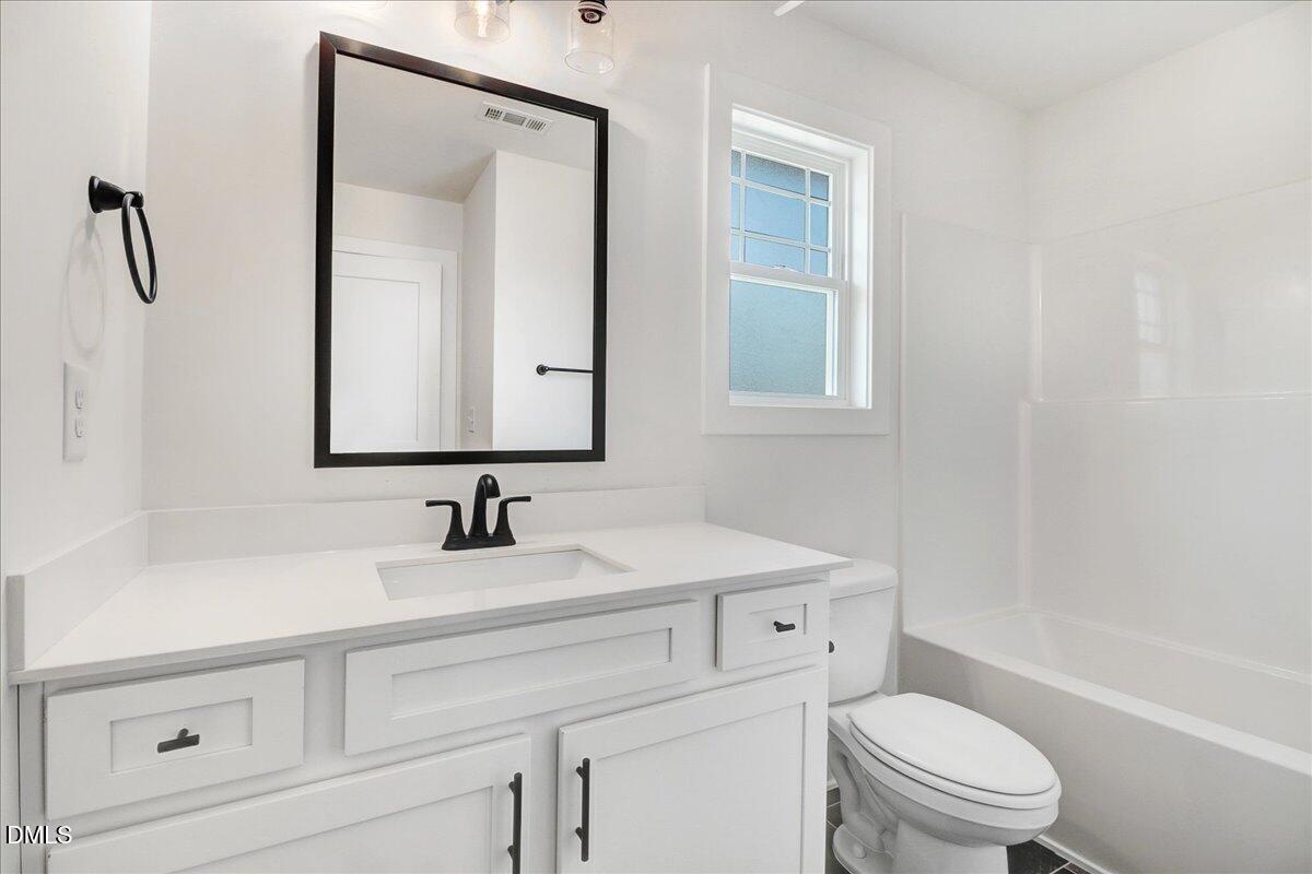2 Galway Road Lillington, NC 27546 - Photo 31 of 37 a bathroom with a toilet sink and mirror