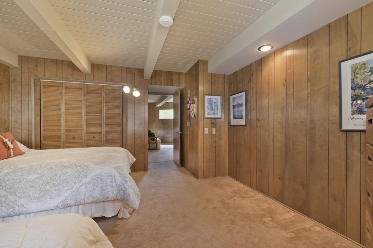 2563 Old Mammoth Road Mammoth Lakes, CA 93546 - Photo 13 of 49 a spacious bedroom with a bed and a chandelier