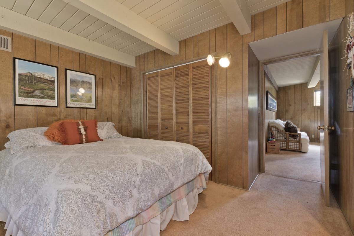 2563 Old Mammoth Road Mammoth Lakes, CA 93546 - Photo 14 of 49 a bedroom with a large bed and a chandelier