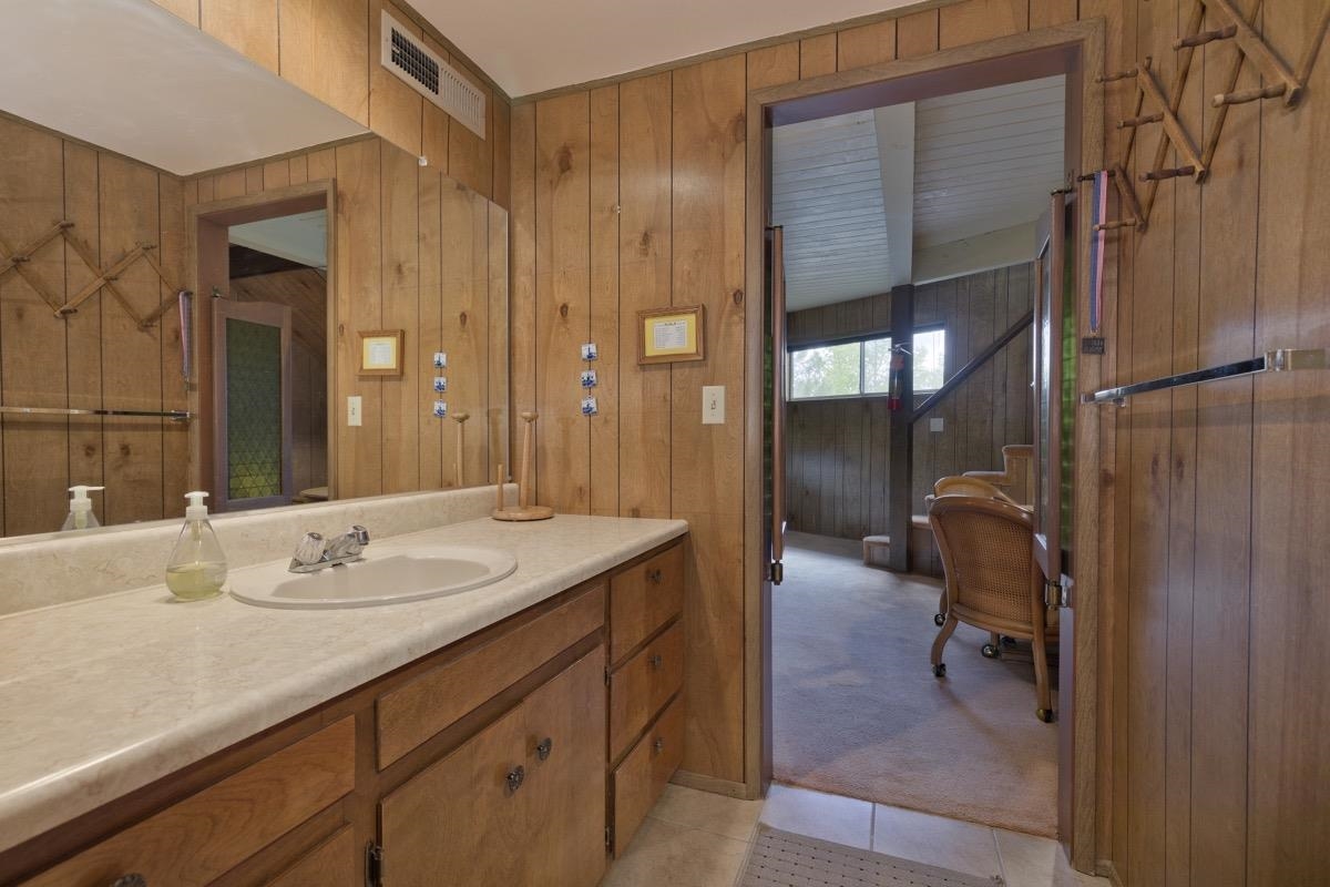 2563 Old Mammoth Road Mammoth Lakes, CA 93546 - Photo 20 of 49 a en suite bathroom with a granite countertop sink and a mirror