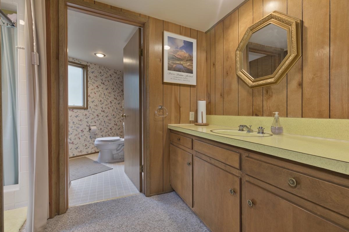 2563 Old Mammoth Road Mammoth Lakes, CA 93546 - Photo 21 of 49 a bathroom with a toilet a sink and mirror
