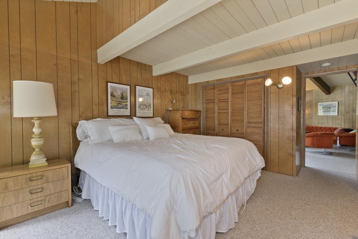 2563 Old Mammoth Road Mammoth Lakes, CA 93546 - Photo 30 of 49 a bedroom with a bed a lamp and a large window