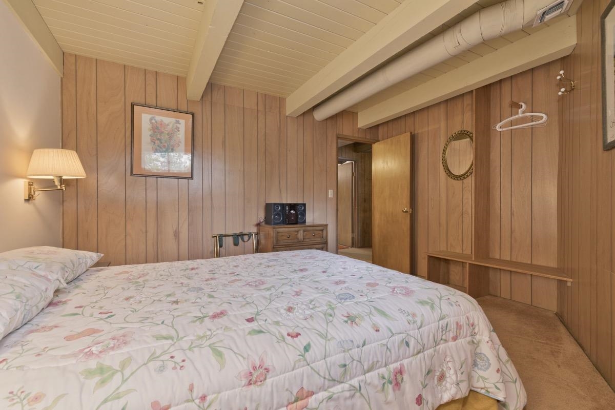 2563 Old Mammoth Road Mammoth Lakes, CA 93546 - Photo 9 of 49 a large bed in a bedroom next to a window and a mirror