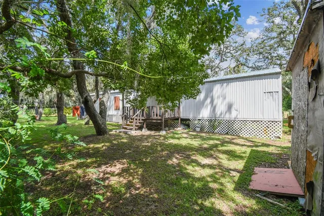 a backyard of a house with table and chairs