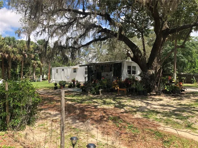 a view of a house with snow on the background