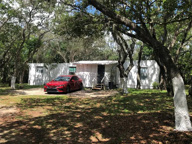 a view of a yard with car parked