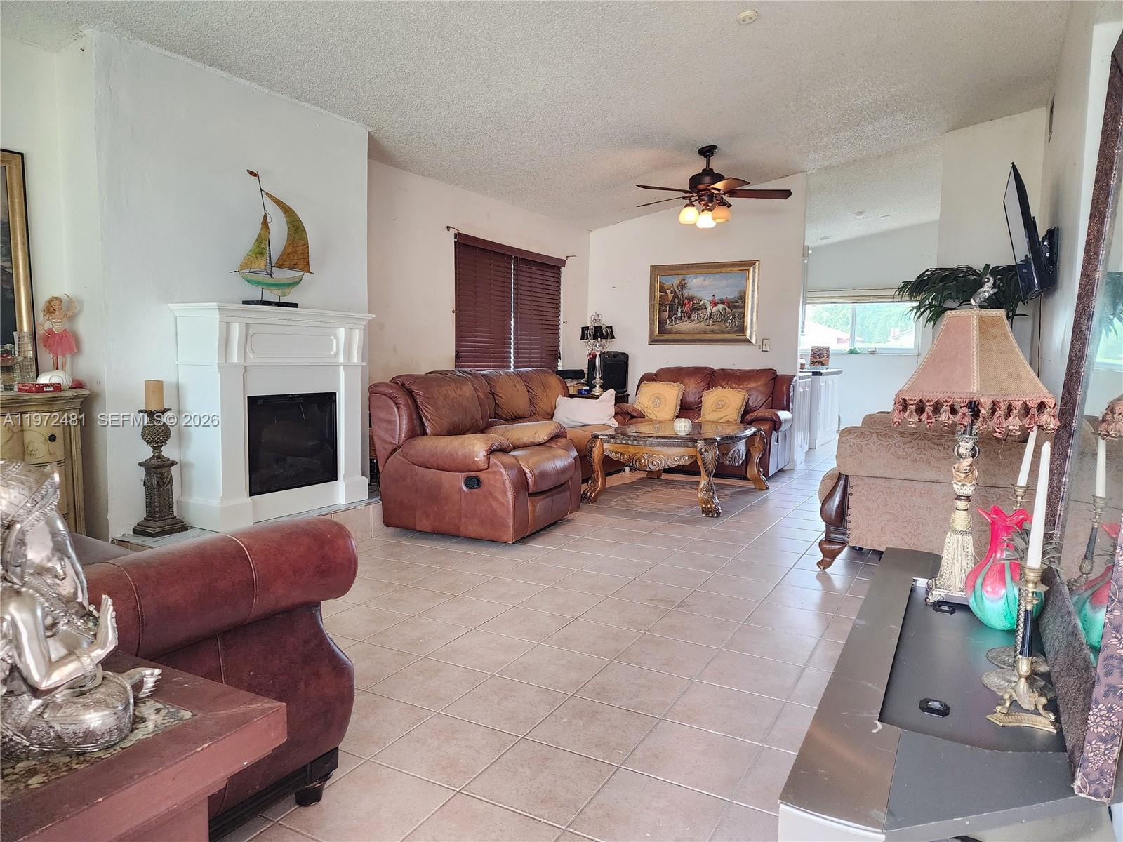 2623 Harding Street Hollywood, FL 33020 - Photo 2 of 12 a living room with furniture and a fireplace