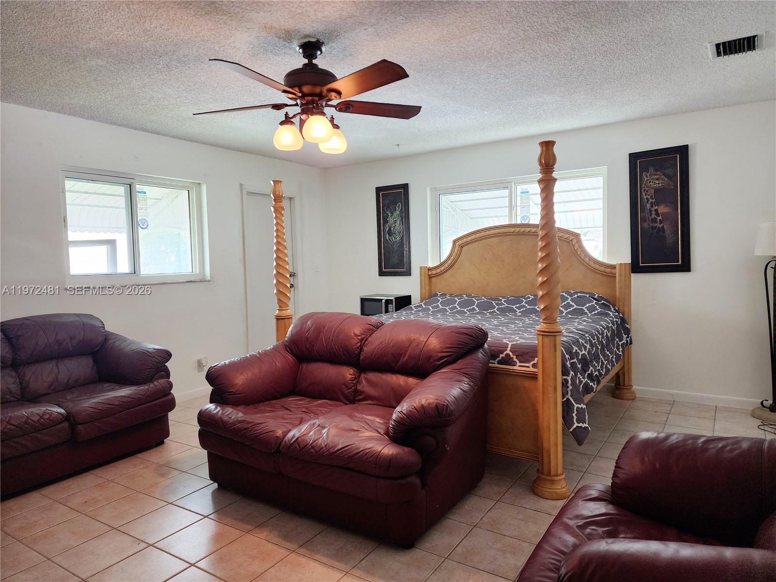 2623 Harding Street Hollywood, FL 33020 - Photo 5 of 12 a living room with furniture and a ceiling fan