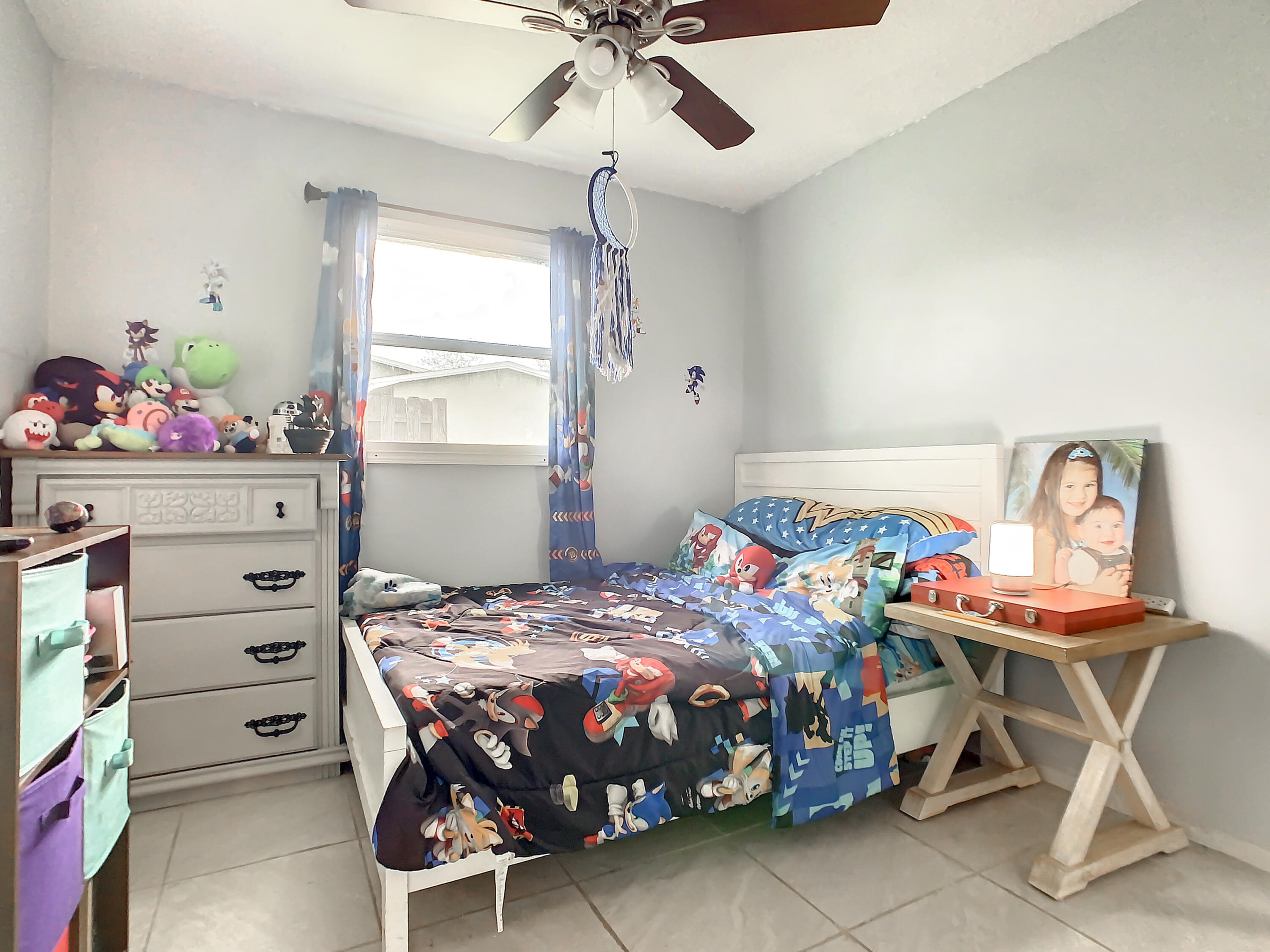 1956 Nottingham Road Melbourne, FL 32935 - Photo 14 of 32 a bedroom with a bed and a table in it