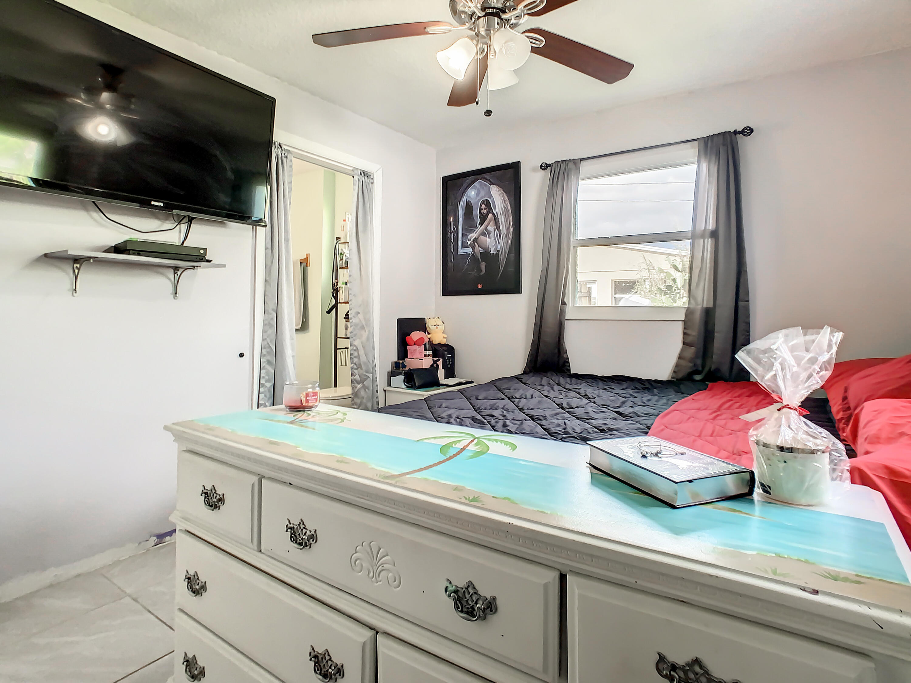 1956 Nottingham Road Melbourne, FL 32935 - Photo 19 of 32 a bedroom with a bed and a flat screen tv