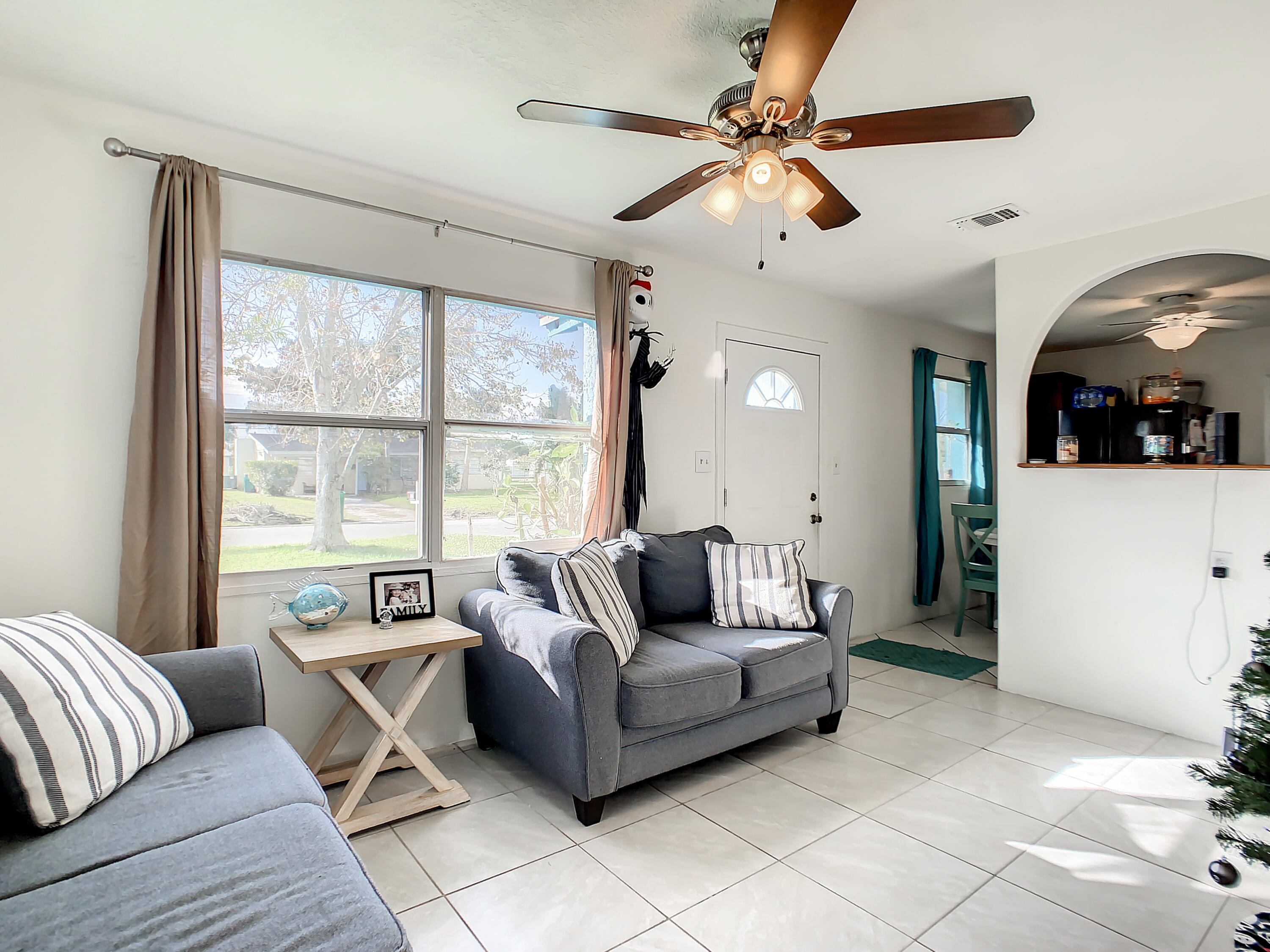 1956 Nottingham Road Melbourne, FL 32935 - Photo 7 of 32 a living room with furniture and a large window