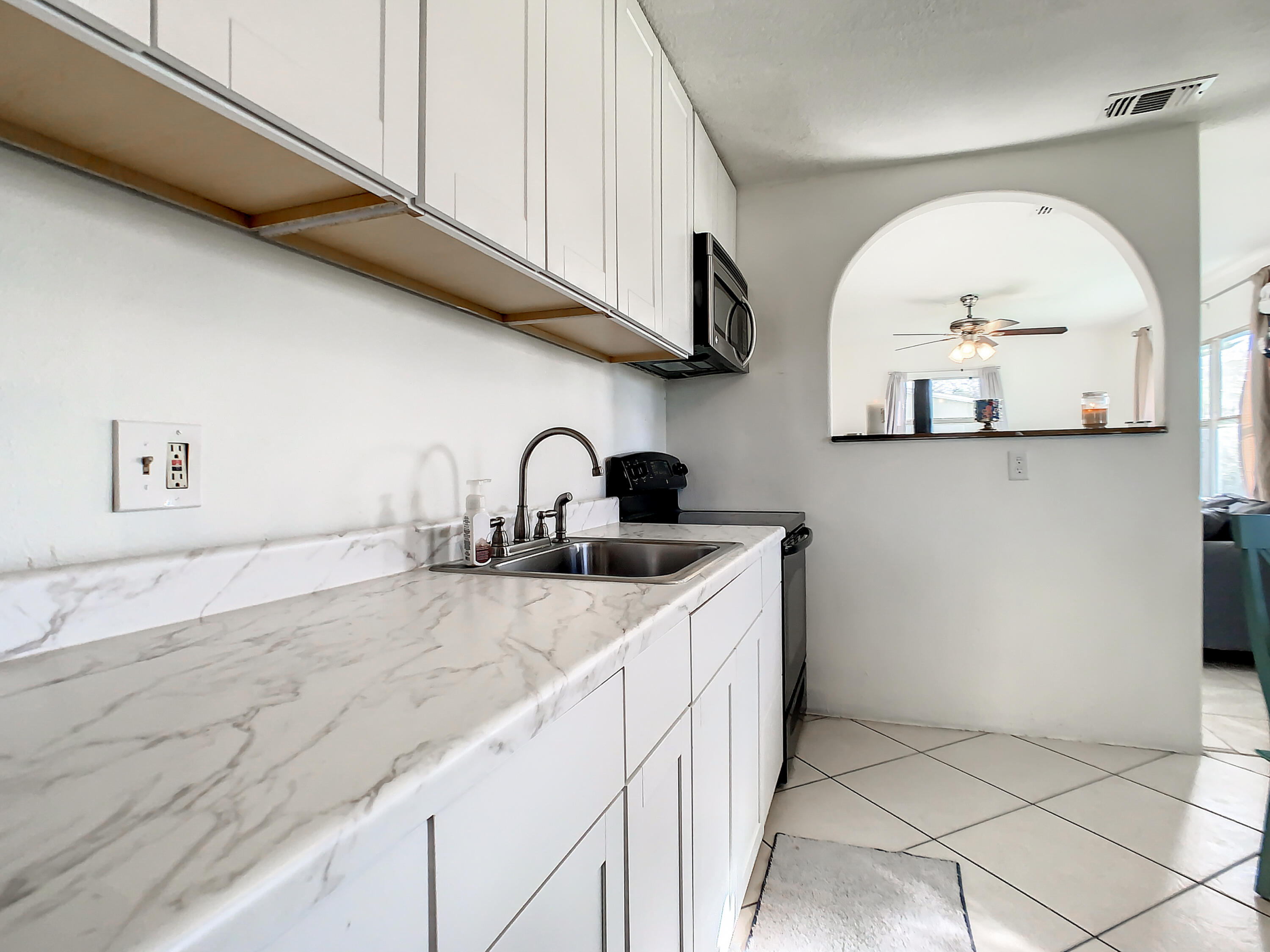 1956 Nottingham Road Melbourne, FL 32935 - Photo 8 of 32 a kitchen with a sink a stove and cabinets