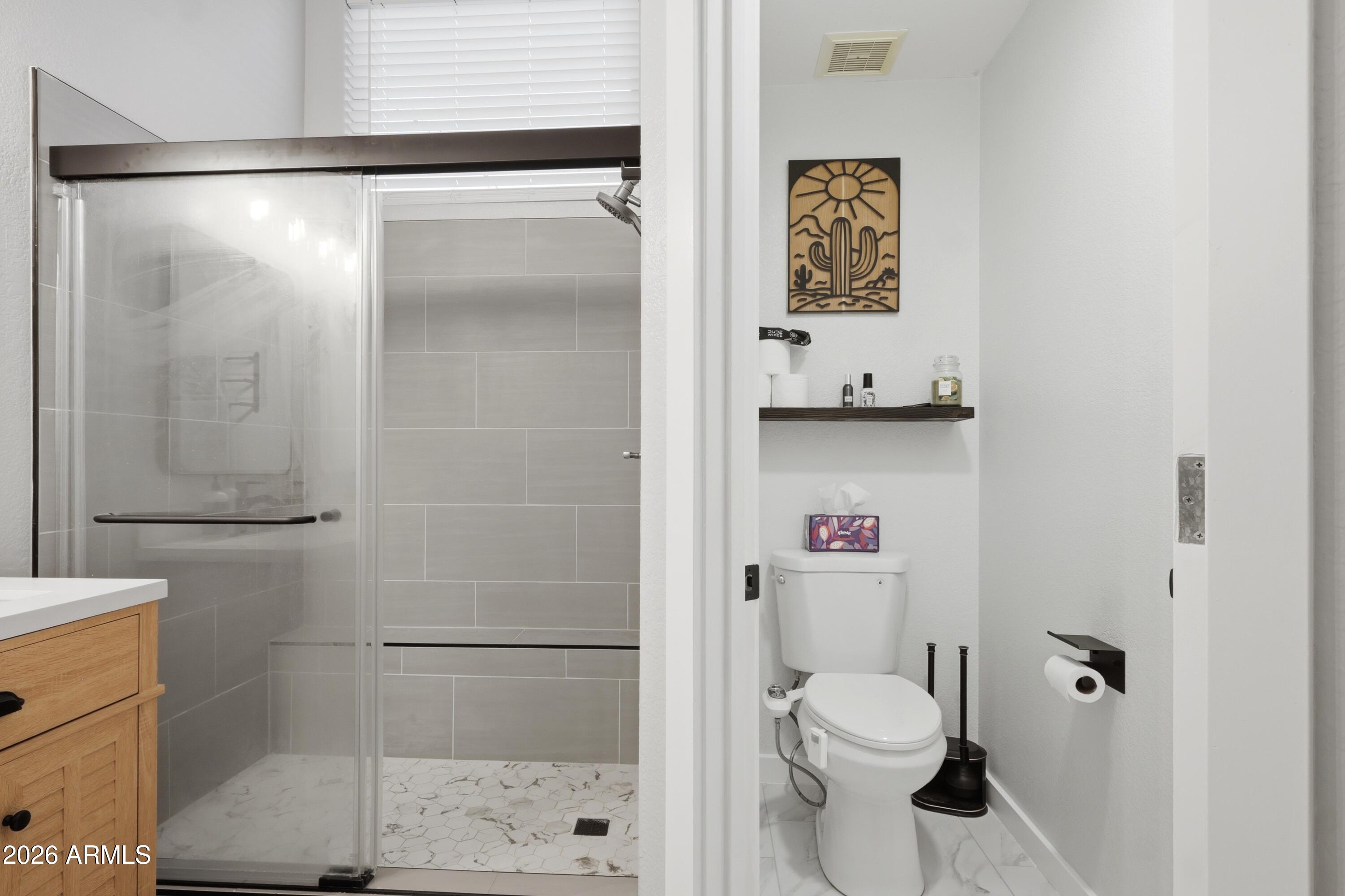661 North Joshua Tree Lane Gilbert, AZ 85234 - Photo 24 of 47 a bathroom with a toilet and a shower