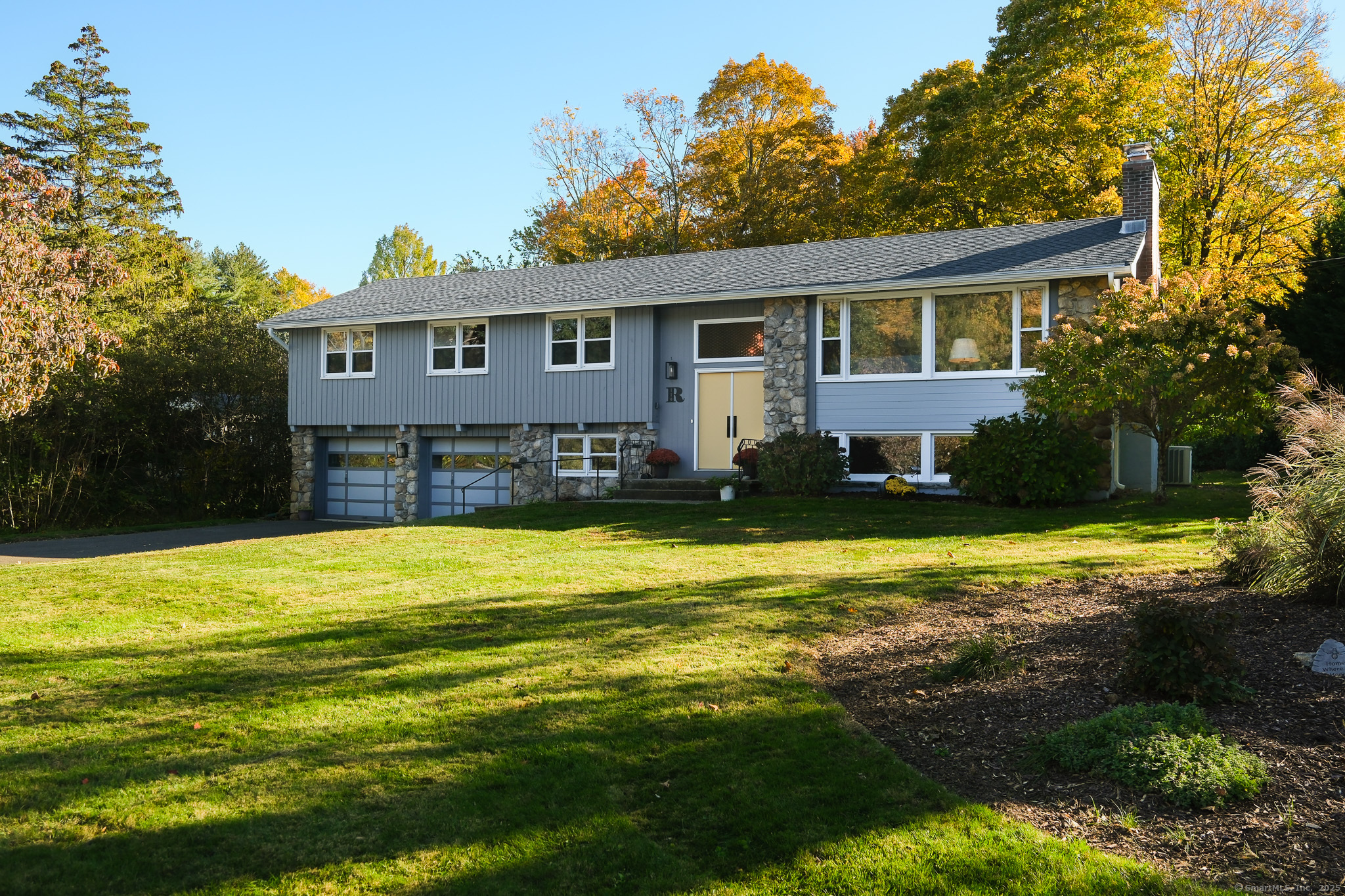 a front view of a house with swimming pool having outdoor seating
