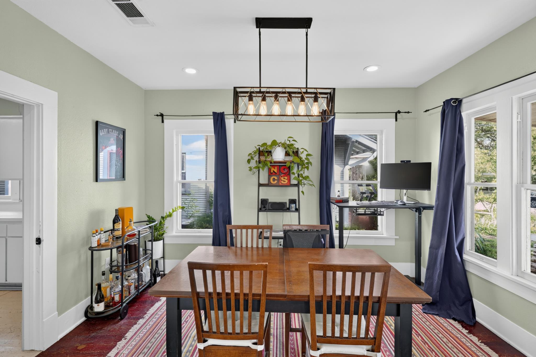 307 East 35th Street, Unit A Austin, TX 78705 - Photo 19 of 40 An inviting dining area offers generous natural light, creating an ideal setting for meals and entertaining.