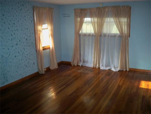 203 Mary Coburn Road Springfield, MA 01129 - Photo 8 of 30 an empty room with wooden floor and windows