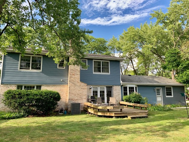 2785 Shannon Road Northbrook, IL 60062 - Photo 20 of 21 a front view of a house with a garden and swimming pool