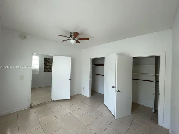 a view of a livingroom with a chandelier fan and refrigerator