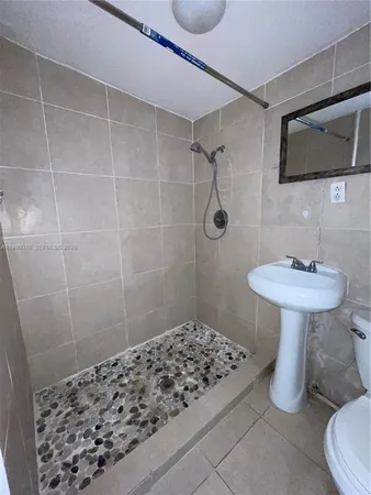 a bathroom with a sink toilet and shower