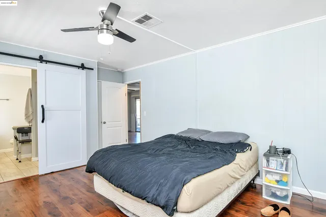 a spacious bedroom with a bed and a chandelier