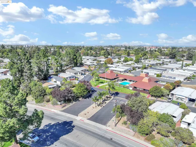 an aerial view of residential houses with outdoor space and lake view