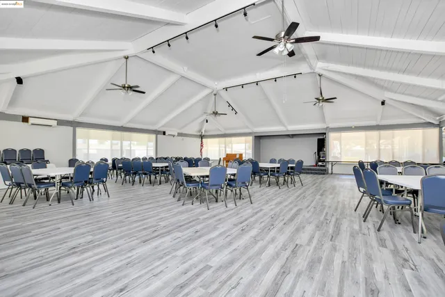 a view of a house with backyard sitting area and garden