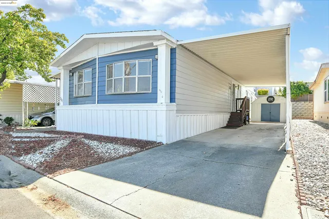 a view of a house with a backyard and a garage