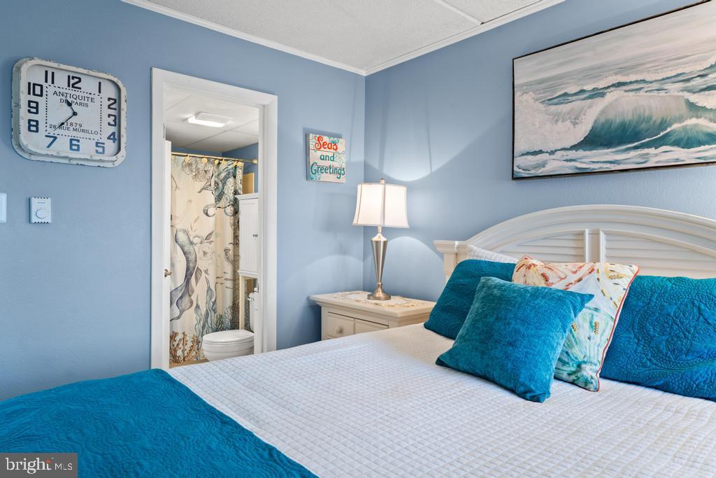 169 Jamestown Road, Unit 20601 Ocean City, MD 21842 - Photo 15 of 35 a bedroom with a bed and painting on the wall