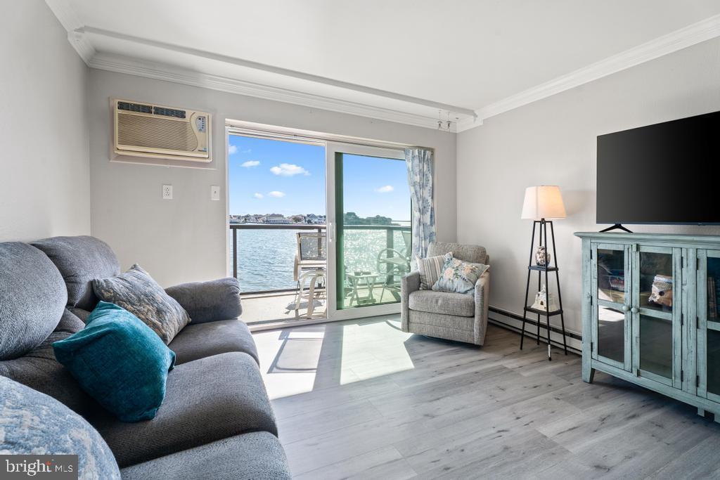 169 Jamestown Road, Unit 20601 Ocean City, MD 21842 - Photo 29 of 35 a living room with furniture and a flat screen tv