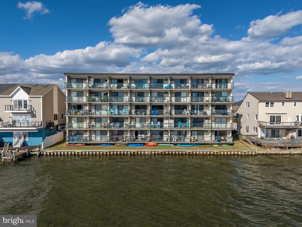 169 Jamestown Road, Unit 20601 Ocean City, MD 21842 - Photo 3 of 35 a view of swimming pool with outdoor seating and lake view