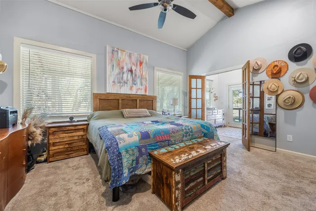 a bedroom with a bed and flat screen tv