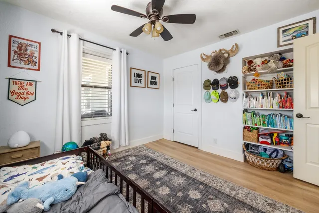 a bedroom with bed and a book shelf