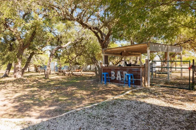 a view of a house with a large tree