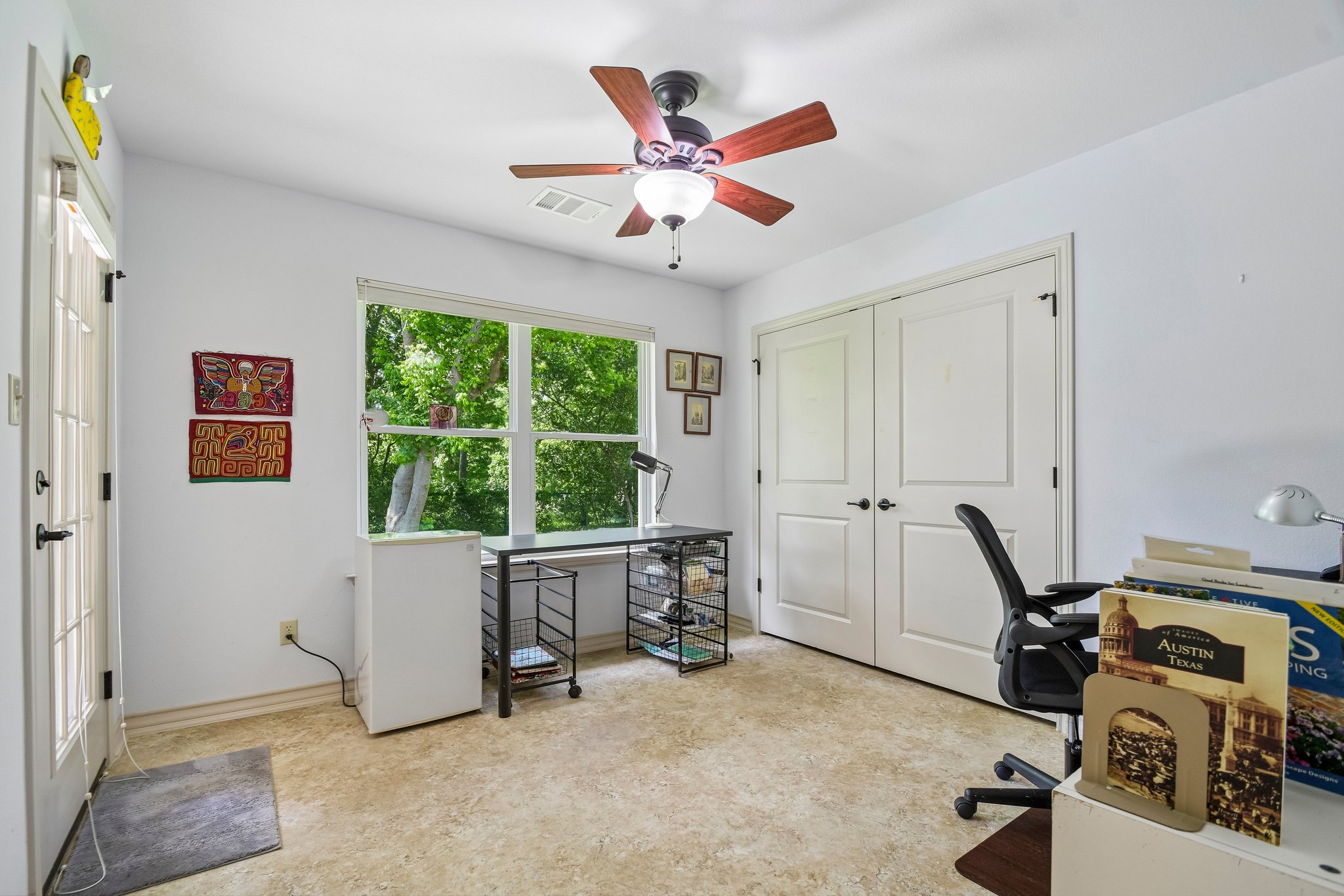 307 West 4th Street Elgin, TX 78621 - Photo 25 of 40 Interior space featuring a window with exterior tree views, a ceiling fan with light fixture, and double paneled closet doors