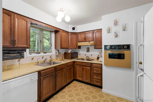 a kitchen with a sink stove and window