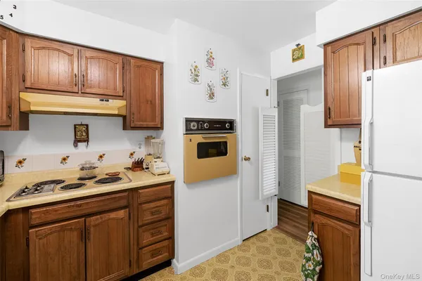 a kitchen with stainless steel appliances granite countertop a refrigerator and a stove top oven
