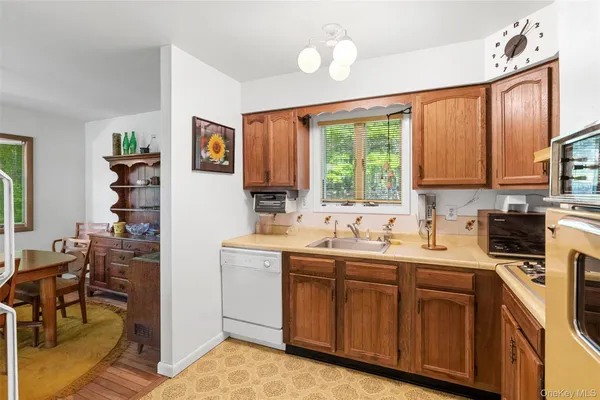 a kitchen with a sink cabinets and window