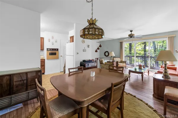 a dining room with furniture window and wooden floor