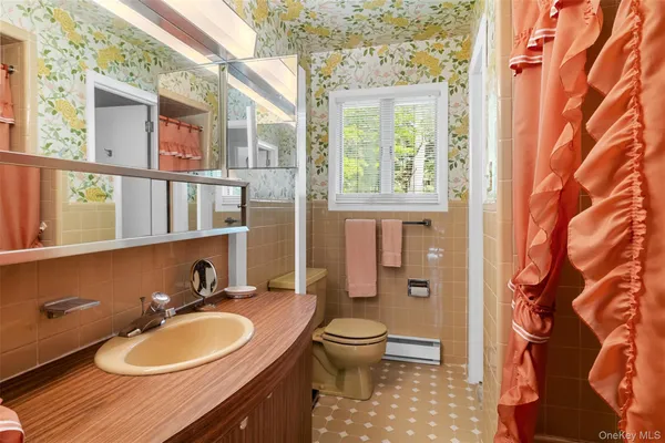 a bathroom with a sink a toilet and a mirror