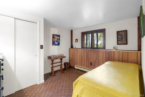 a bedroom with a bed and a window